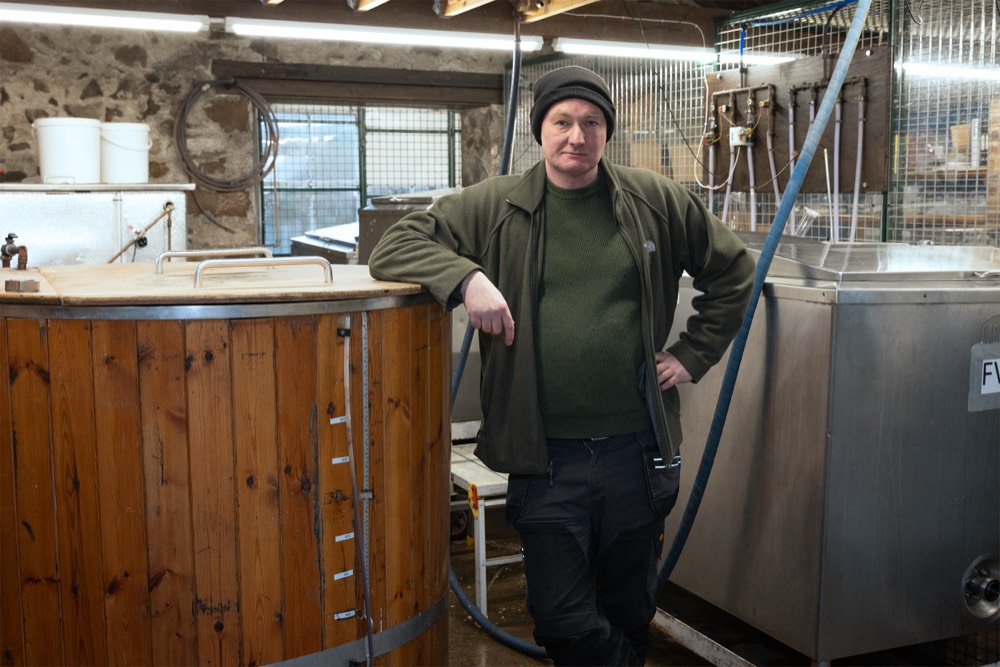 Brewer Dan in the Strands Brewery, standing beside the mash tun